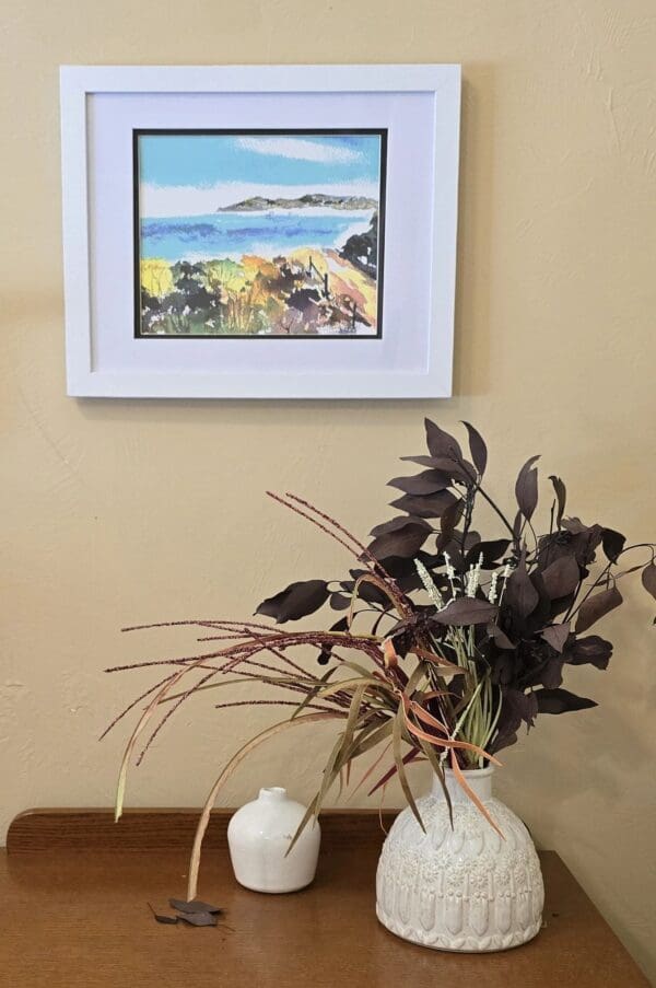 A painting of a beach and some plants in a vase