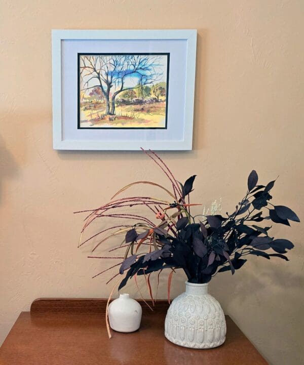 A vase and some plants on a table