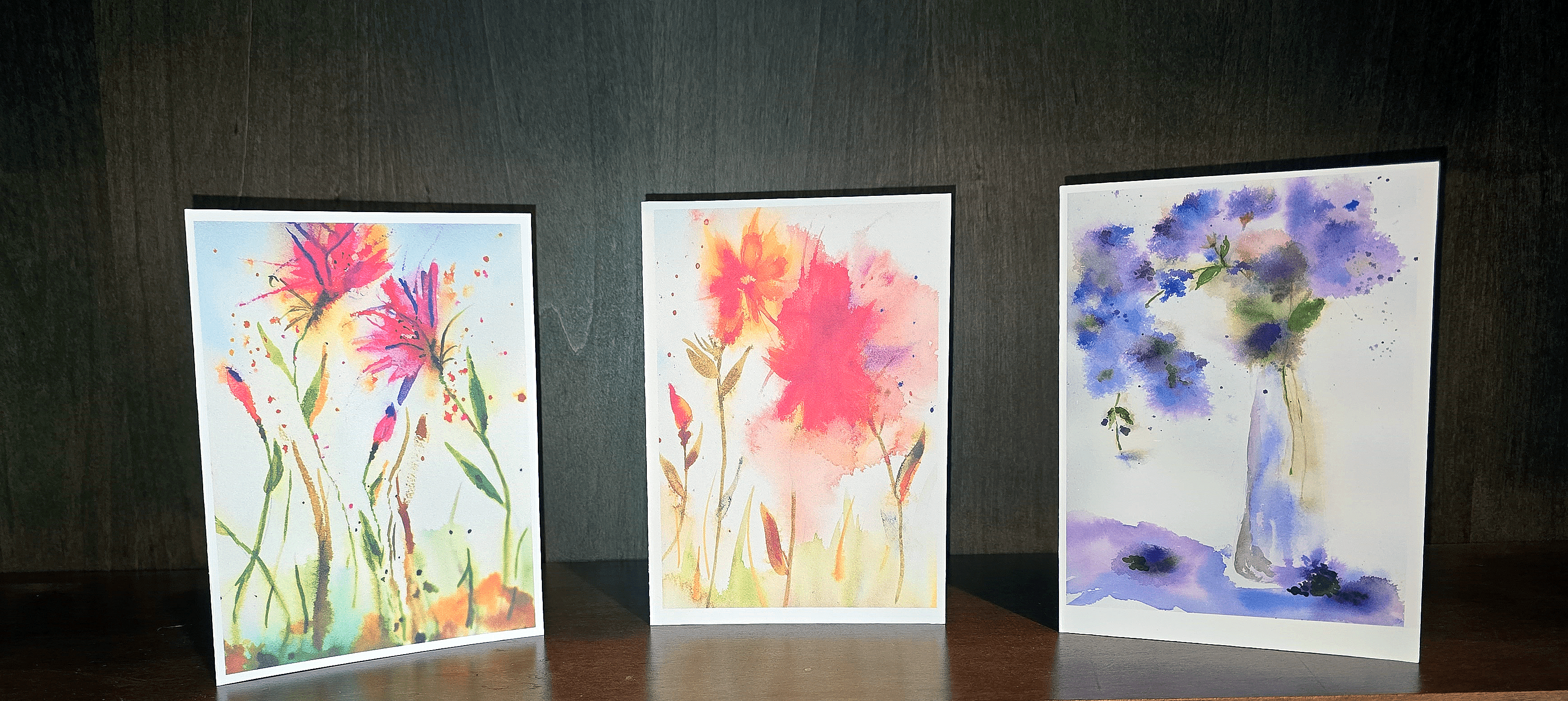 Three cards with flowers on them sitting next to each other.